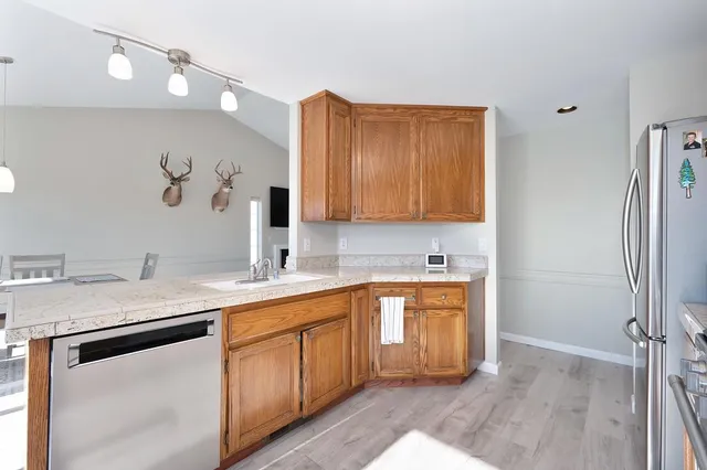 a kitchen with a dining table chairs and white appliances