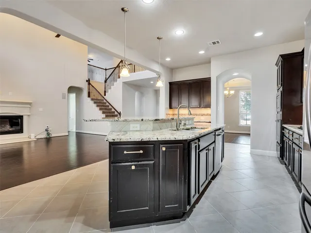 a bathroom with a granite countertop sink a toilet and a large mirror