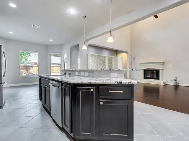 a kitchen with stainless steel appliances granite countertop a sink and stove