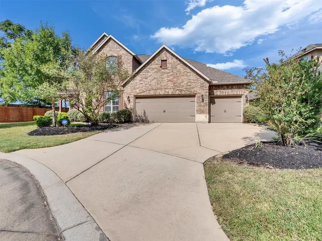 a view of a house with a yard and potted plants