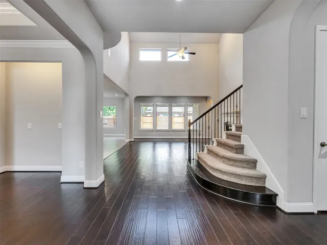 a view of entryway and hall with wooden floor