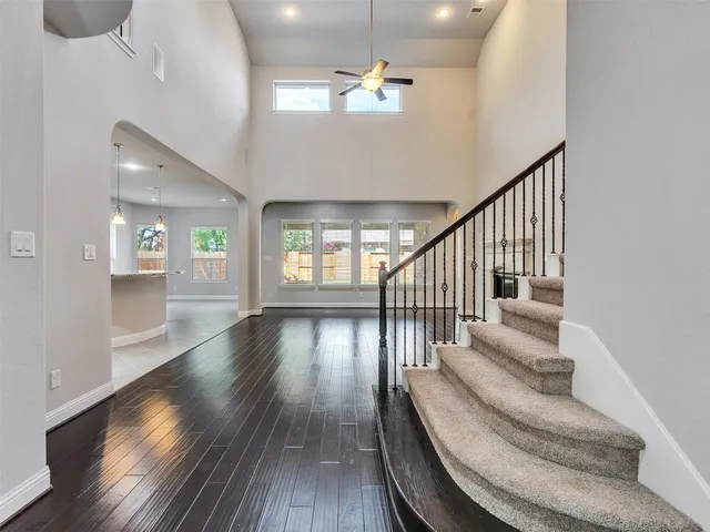 a view of entryway and hall with wooden floor