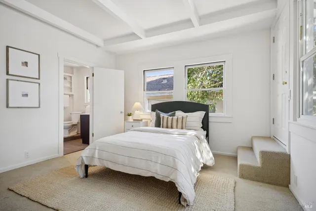 a living room with furniture a rug and a large window