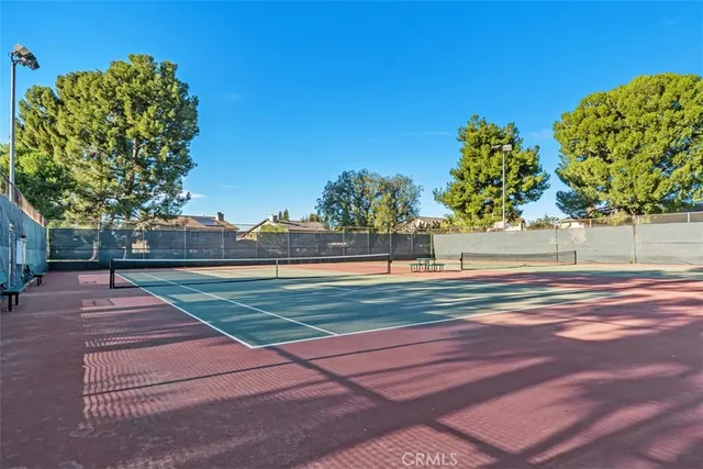 a view of a yard with wooden fence
