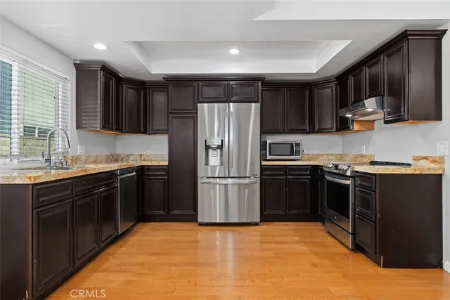 a kitchen with a refrigerator and a sink