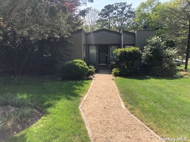 a front view of a house with a yard and a table