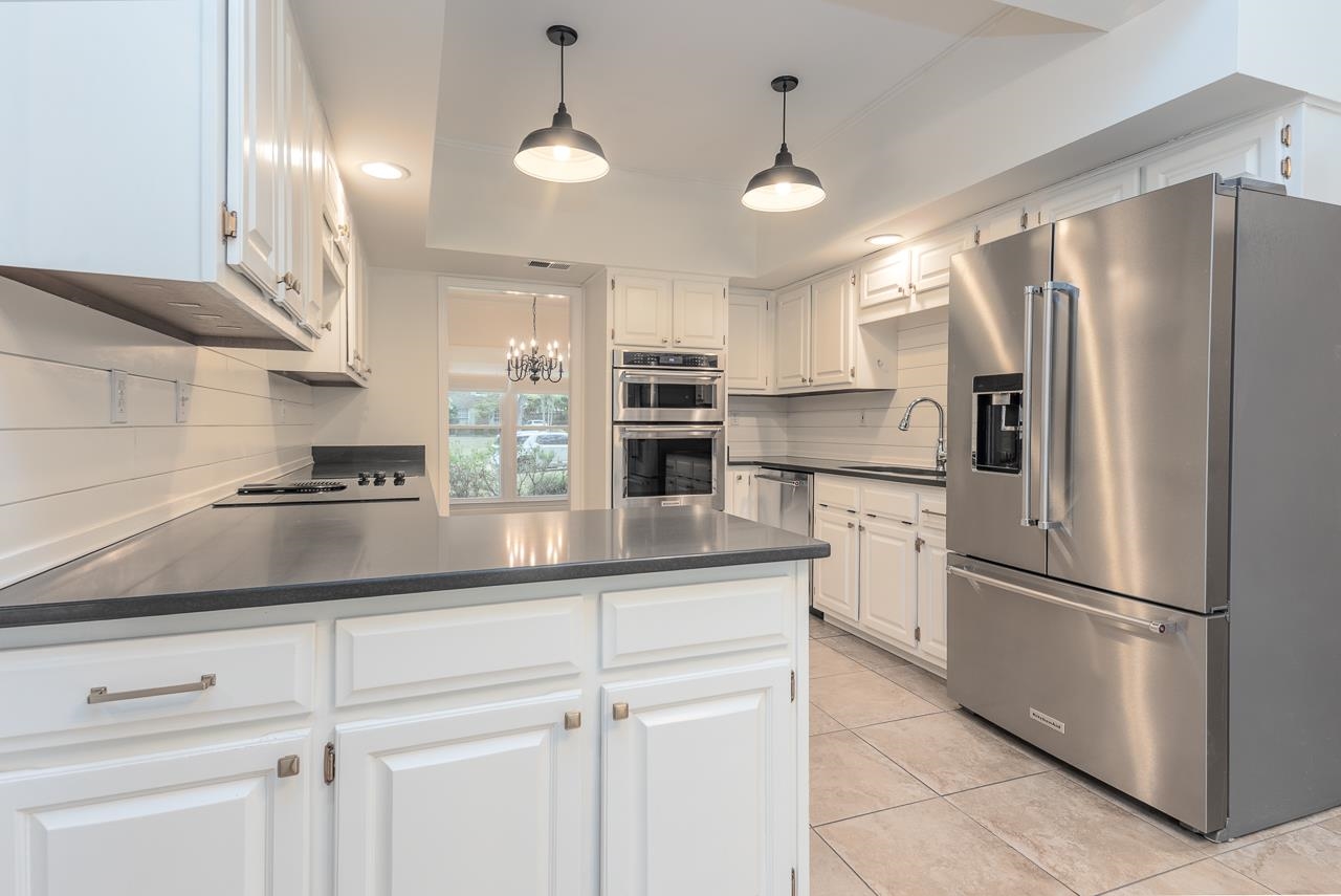 759 West Powell Road Collierville, TN 38017 - Photo 12 of 39 a kitchen with refrigerator and cabinets