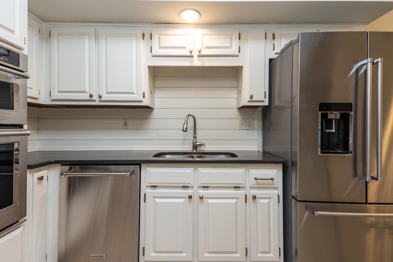 759 West Powell Road Collierville, TN 38017 - Photo 13 of 39 a kitchen with stainless steel appliances a refrigerator and cabinets