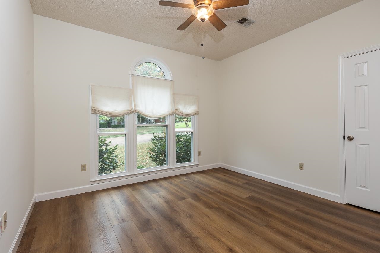 759 West Powell Road Collierville, TN 38017 - Photo 14 of 39 an empty room with wooden floor fan and windows
