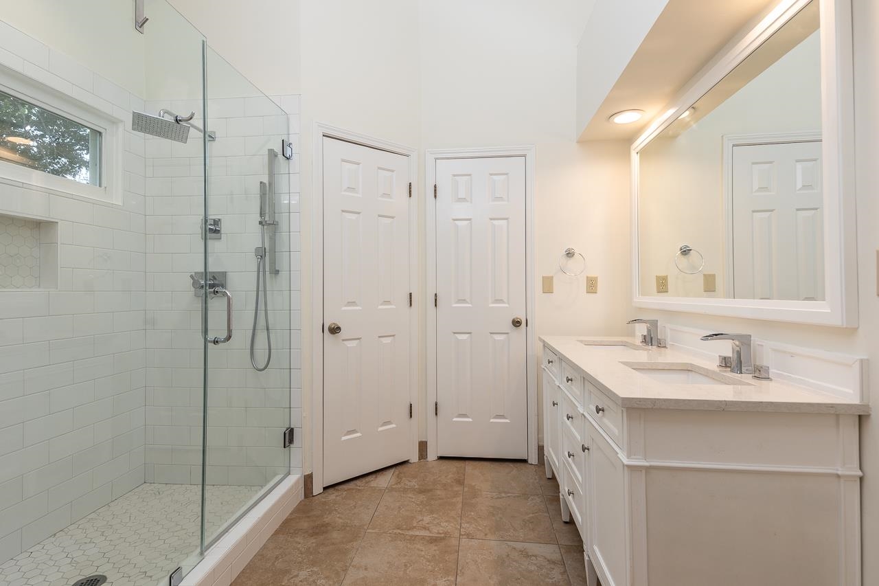759 West Powell Road Collierville, TN 38017 - Photo 20 of 39 a bathroom with a shower sink vanity and mirror