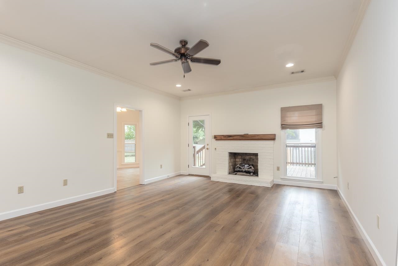 759 West Powell Road Collierville, TN 38017 - Photo 21 of 39 an empty room with wooden floor fireplace and windows
