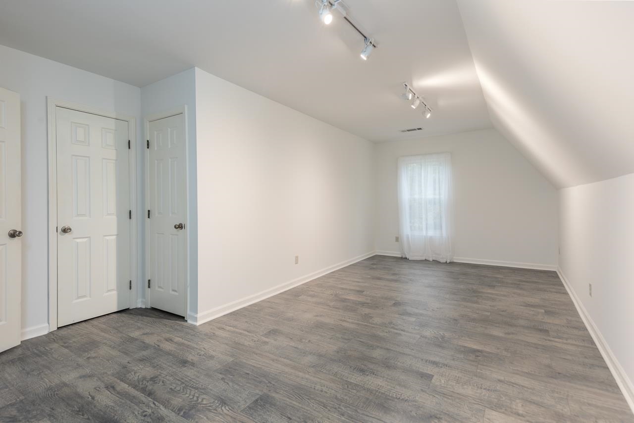 759 West Powell Road Collierville, TN 38017 - Photo 29 of 39 an empty room with wooden floor and windows