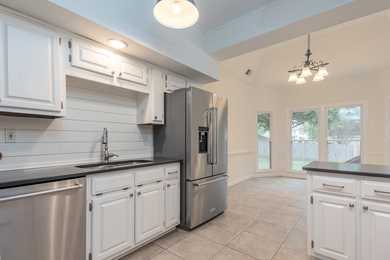 759 West Powell Road Collierville, TN 38017 - Photo 8 of 39 a kitchen with a sink and refrigerator