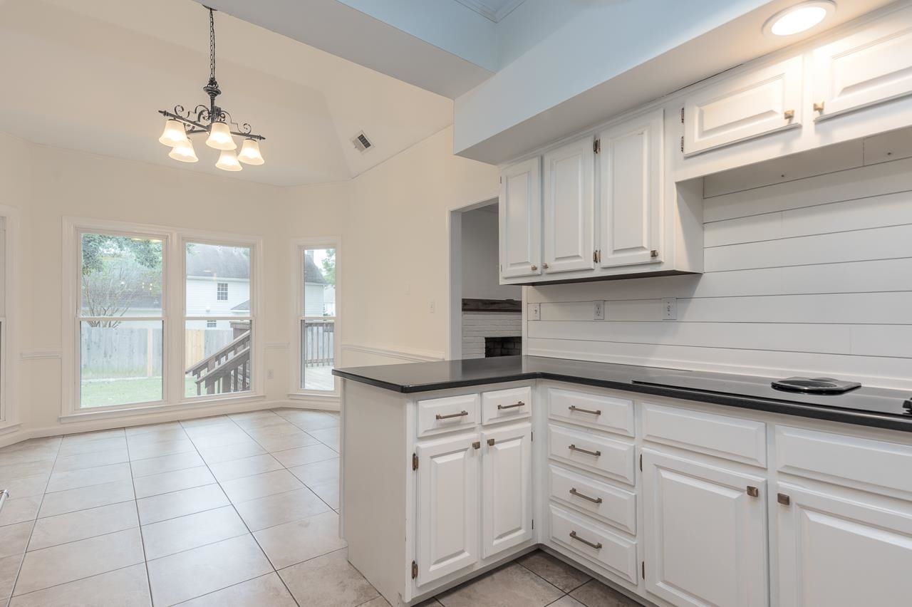 759 West Powell Road Collierville, TN 38017 - Photo 9 of 39 a kitchen with granite countertop white cabinets and white appliances