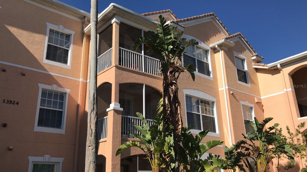 13548 Turtle Marsh Loop, Unit 411 Orlando, FL 32837 - Photo 1 of 1 a front view of a multi story residential apartment building