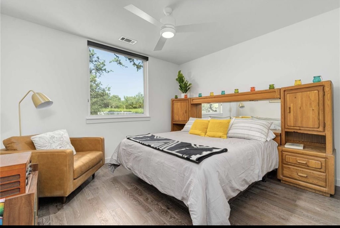 900 South 1st Street, Unit 304 Austin, TX 78704 - Photo 12 of 22 a bedroom with bed couch and window