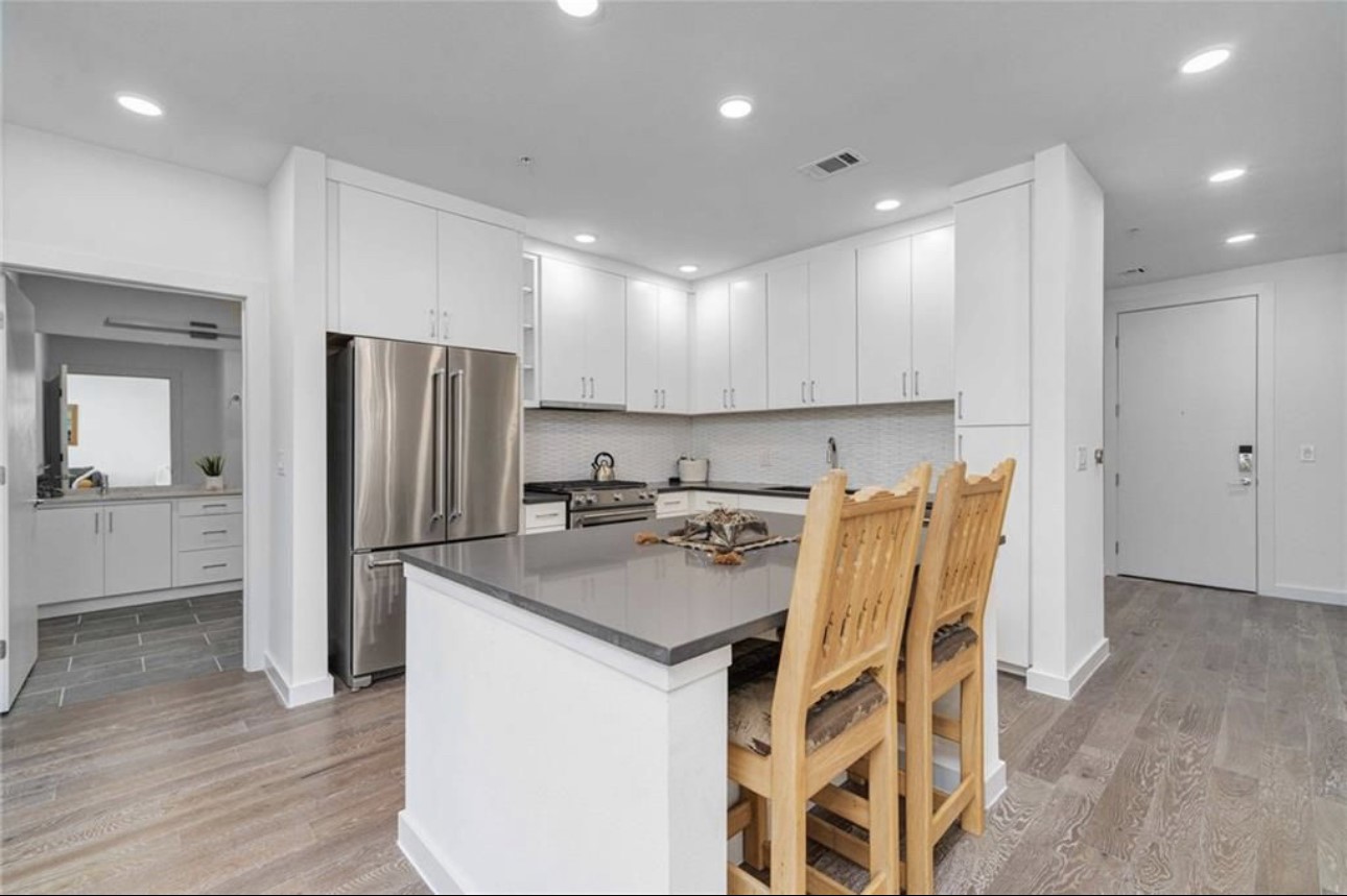900 South 1st Street, Unit 304 Austin, TX 78704 - Photo 6 of 22 a kitchen with a refrigerator a sink and a stove