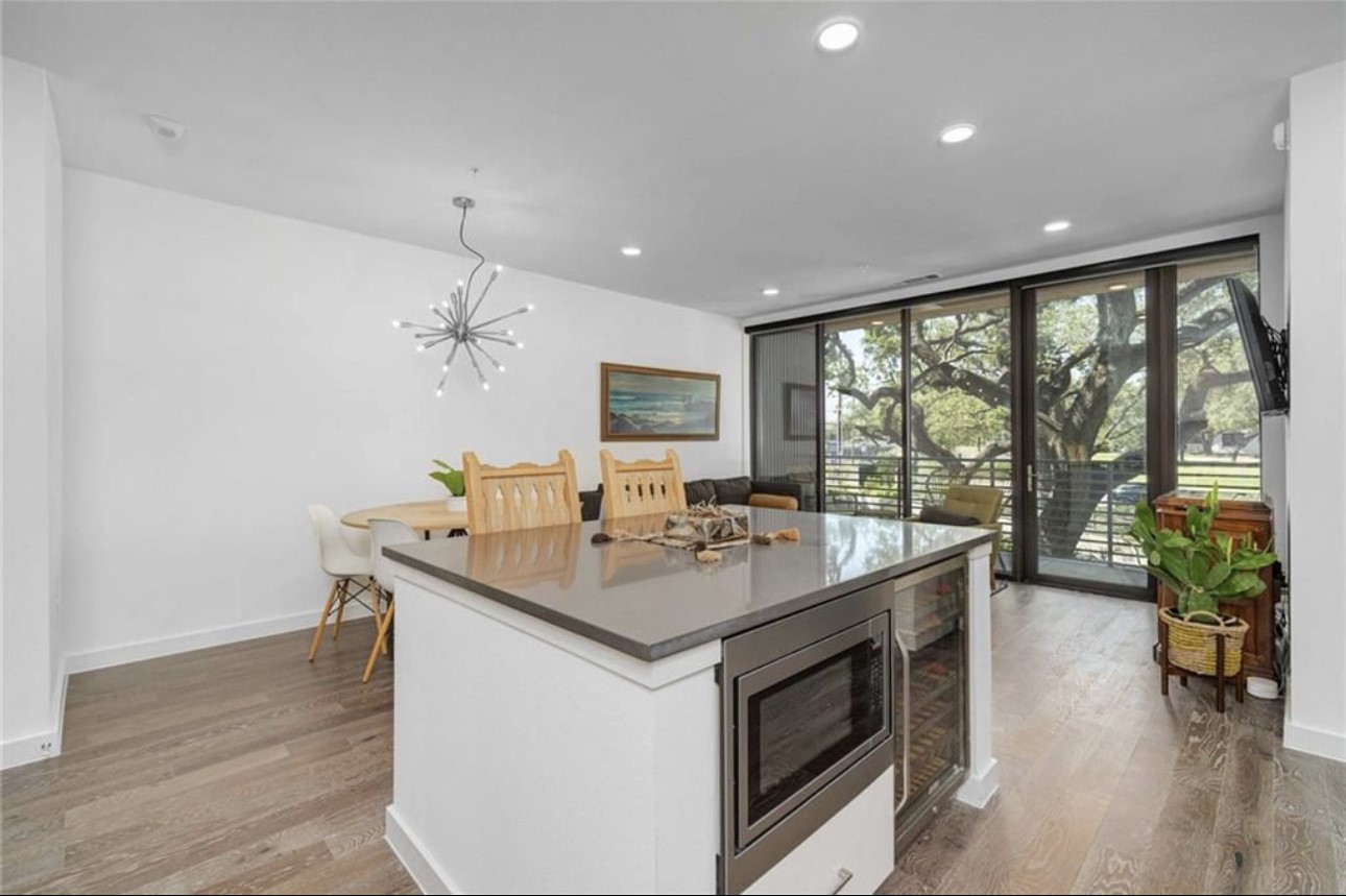 900 South 1st Street, Unit 304 Austin, TX 78704 - Photo 7 of 22 a kitchen with a stove and a large window