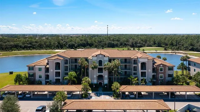 a view of house with yard outdoor seating and lake view