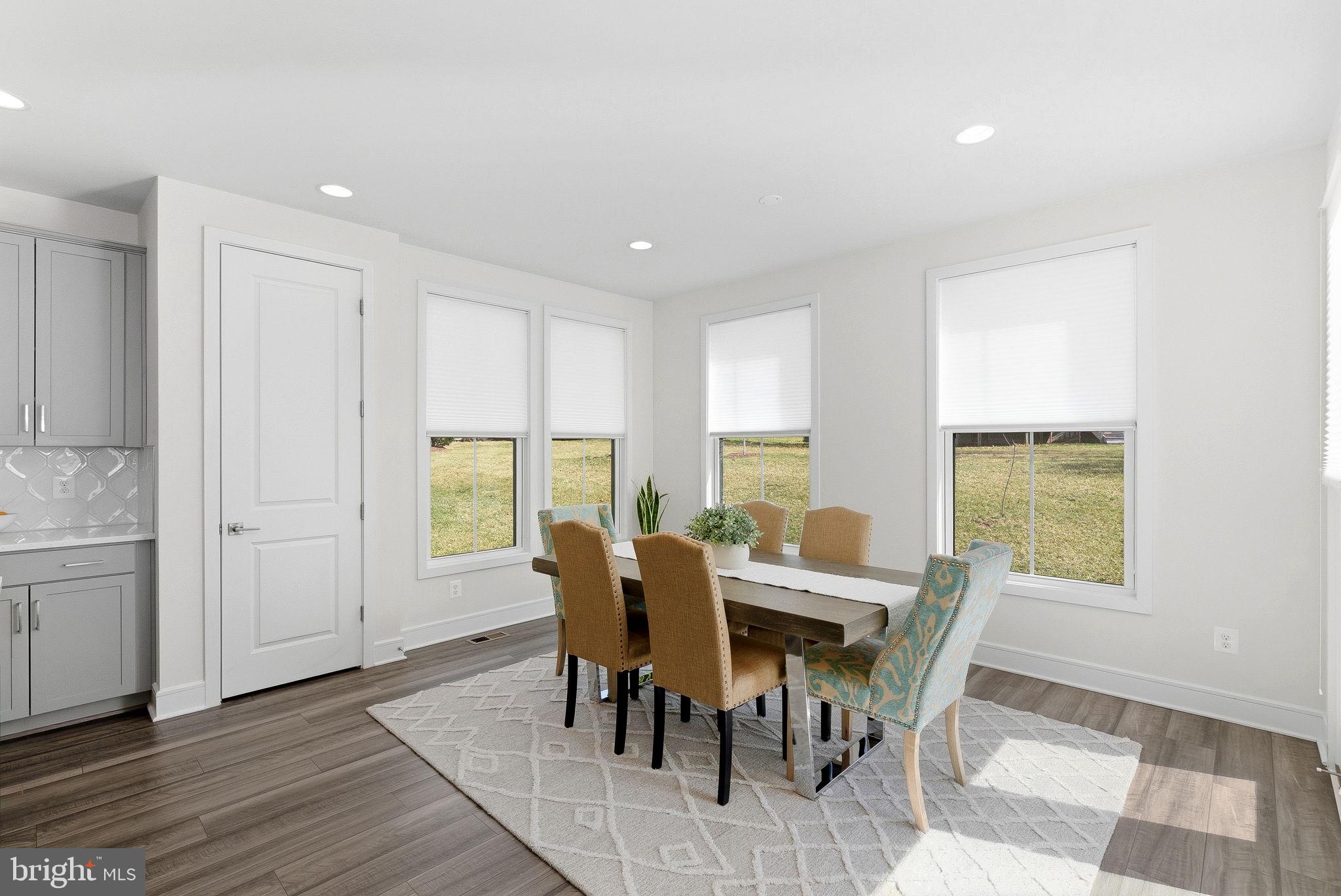 21340 Rainier Lane Broadlands, VA 20148 - Photo 13 of 62 a view of a dining room with furniture and wooden floor