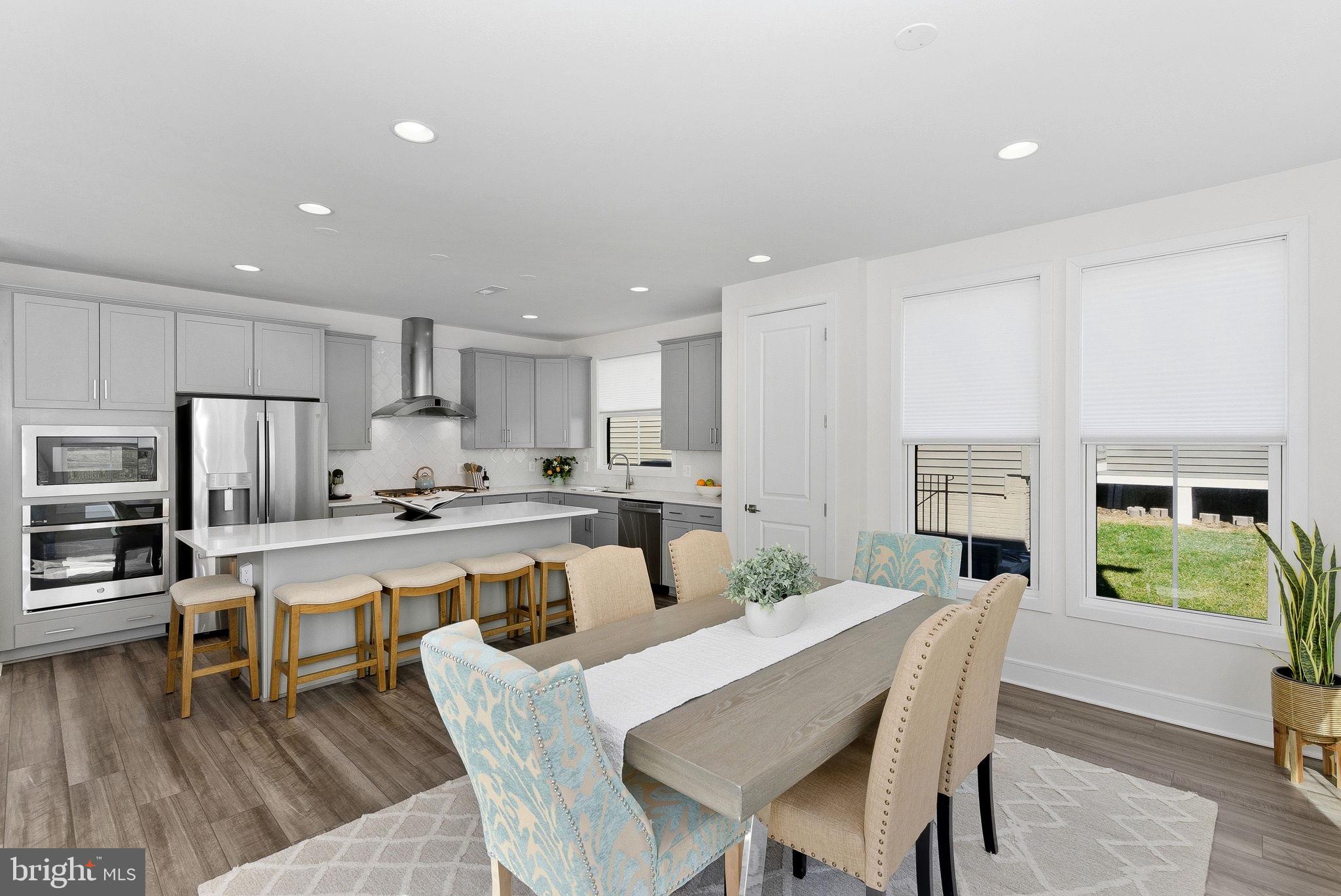 21340 Rainier Lane Broadlands, VA 20148 - Photo 14 of 62 a large kitchen with a table and chairs