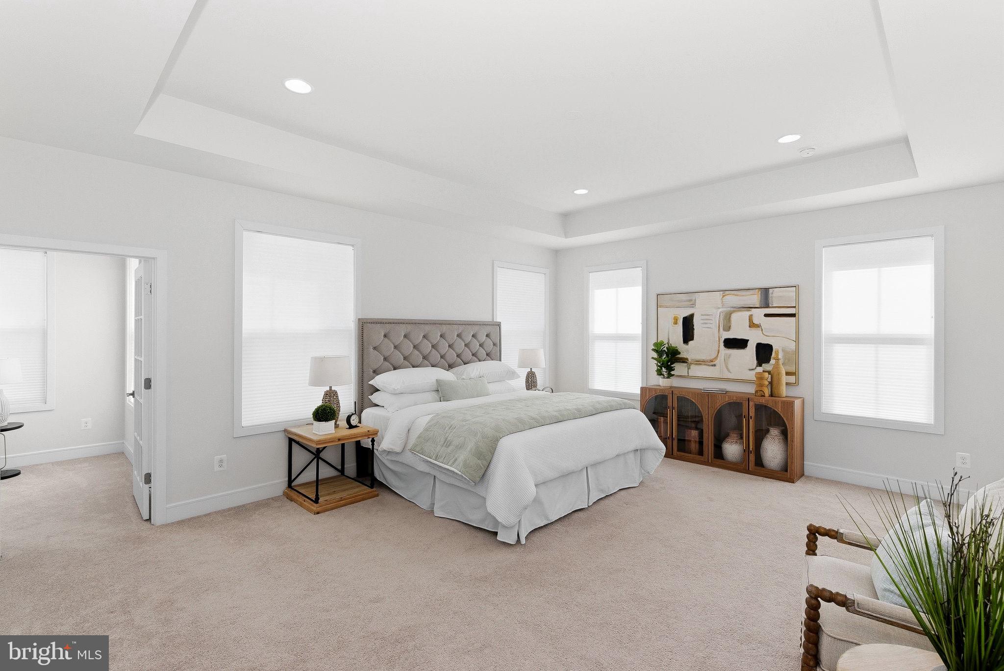 21340 Rainier Lane Broadlands, VA 20148 - Photo 25 of 62 a spacious bedroom with a bed and a couch