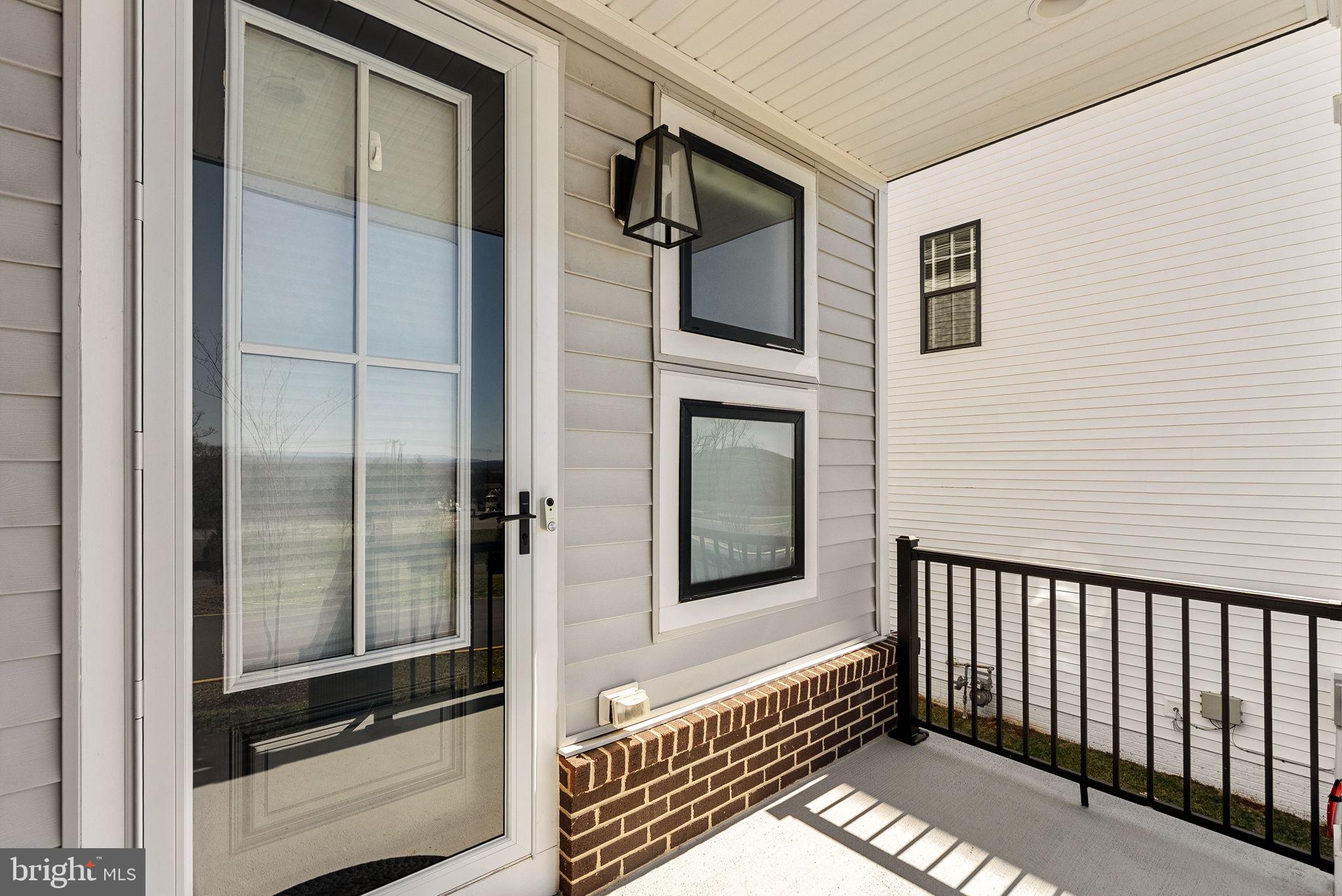 21340 Rainier Lane Broadlands, VA 20148 - Photo 3 of 62 a balcony with a door open to a house