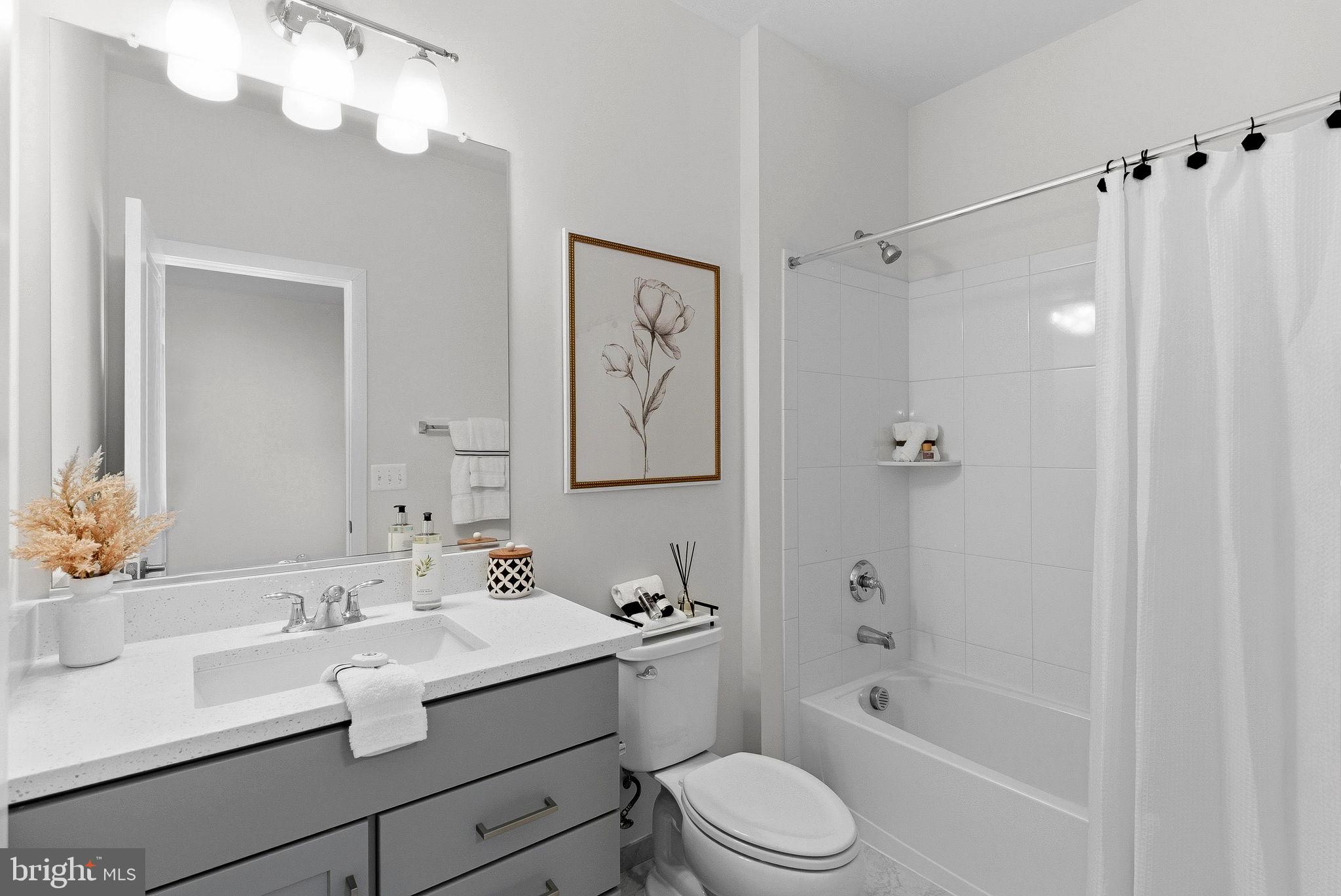 21340 Rainier Lane Broadlands, VA 20148 - Photo 34 of 62 a bathroom with a granite countertop sink a toilet a mirror a bathtub and shower