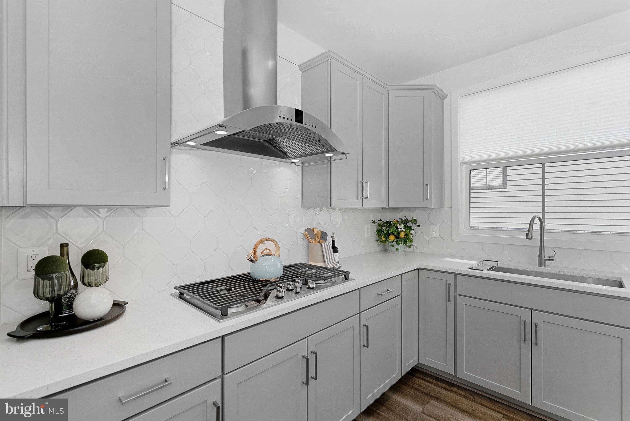 21340 Rainier Lane Broadlands, VA 20148 - Photo 10 of 62 a kitchen with stainless steel appliances a sink a stove and cabinets