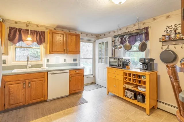 a kitchen with stainless steel appliances a stove a sink and a refrigerator