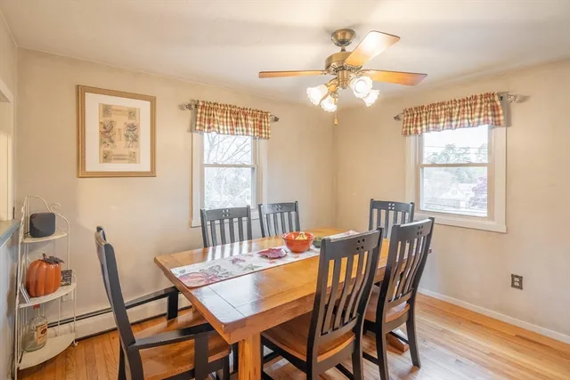 a view of a dining room with furniture a chandelier and wooden floor
