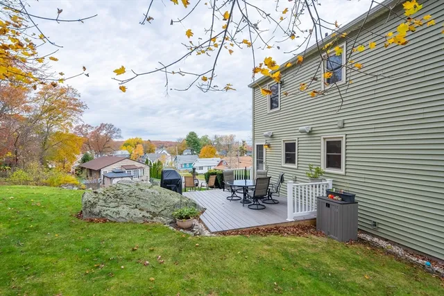 a backyard of a house with table and chairs