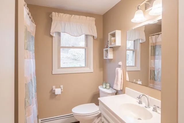 a white toilet sitting next to a bathroom sink and a tub