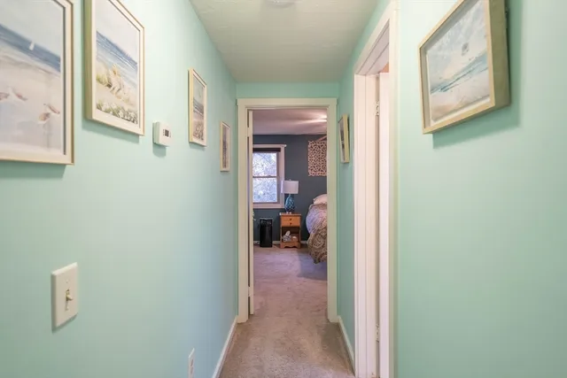 a bedroom with a bed and a flat tv screen on dresser
