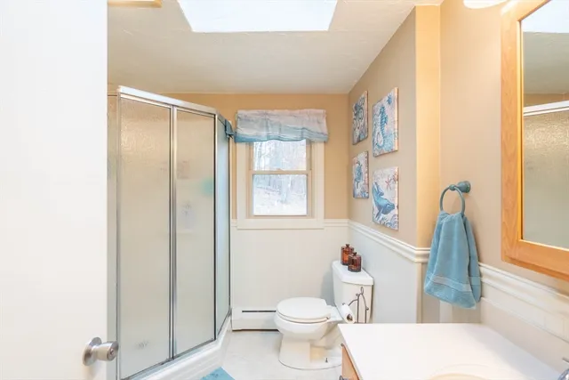 a bathroom with a toilet and a shower curtain