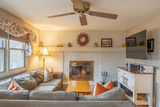 a living room with furniture and a fireplace