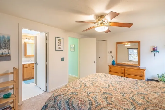 a living room with furniture and a ceiling fan