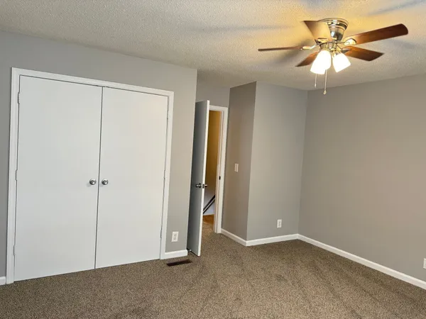 a view of a livingroom with a chandelier fan