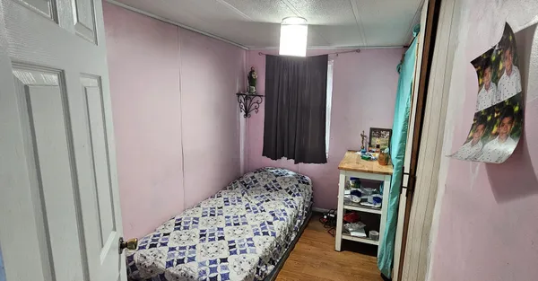 a bedroom with a bed and a rug