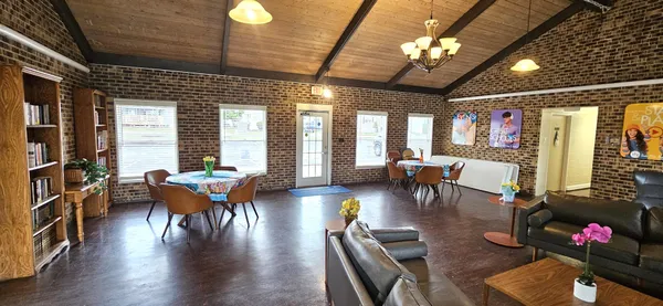 a living room with furniture a chandelier and a fireplace