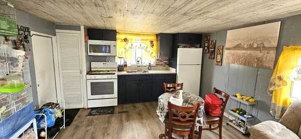 a kitchen with refrigerator and window
