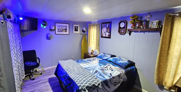 a bedroom with a bed and a desk