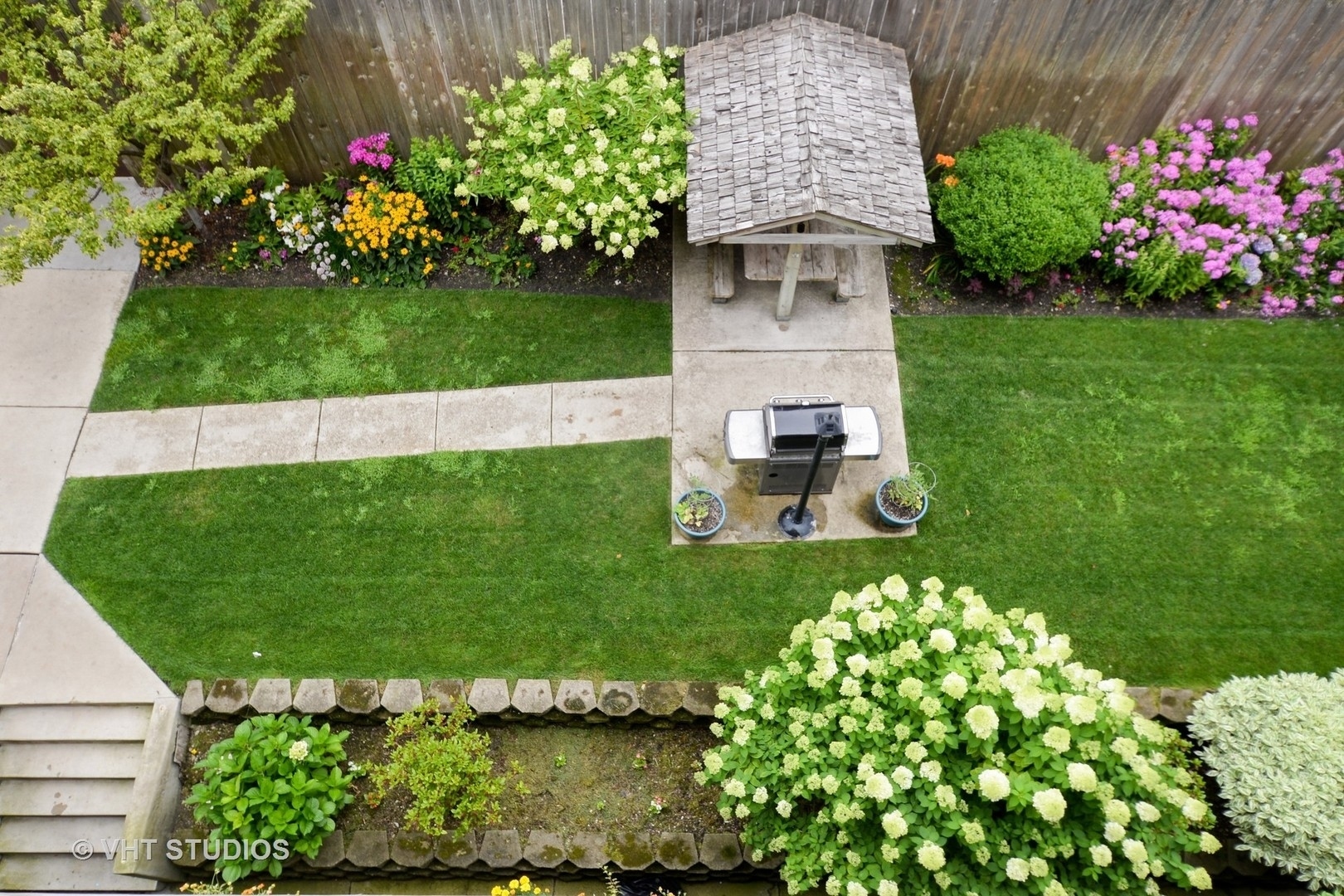 1024 West Byron Street, Unit G Chicago, IL 60613 - Photo 17 of 20 a front view of a house with a yard and fountain in middle