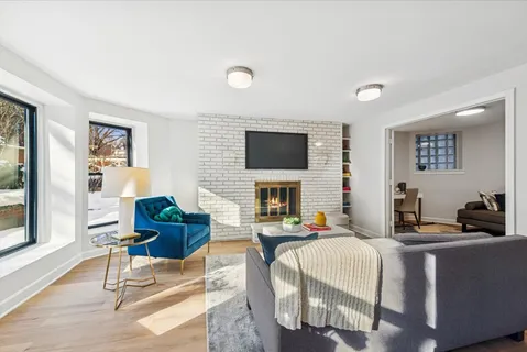 a living room with fireplace furniture and a flat screen tv
