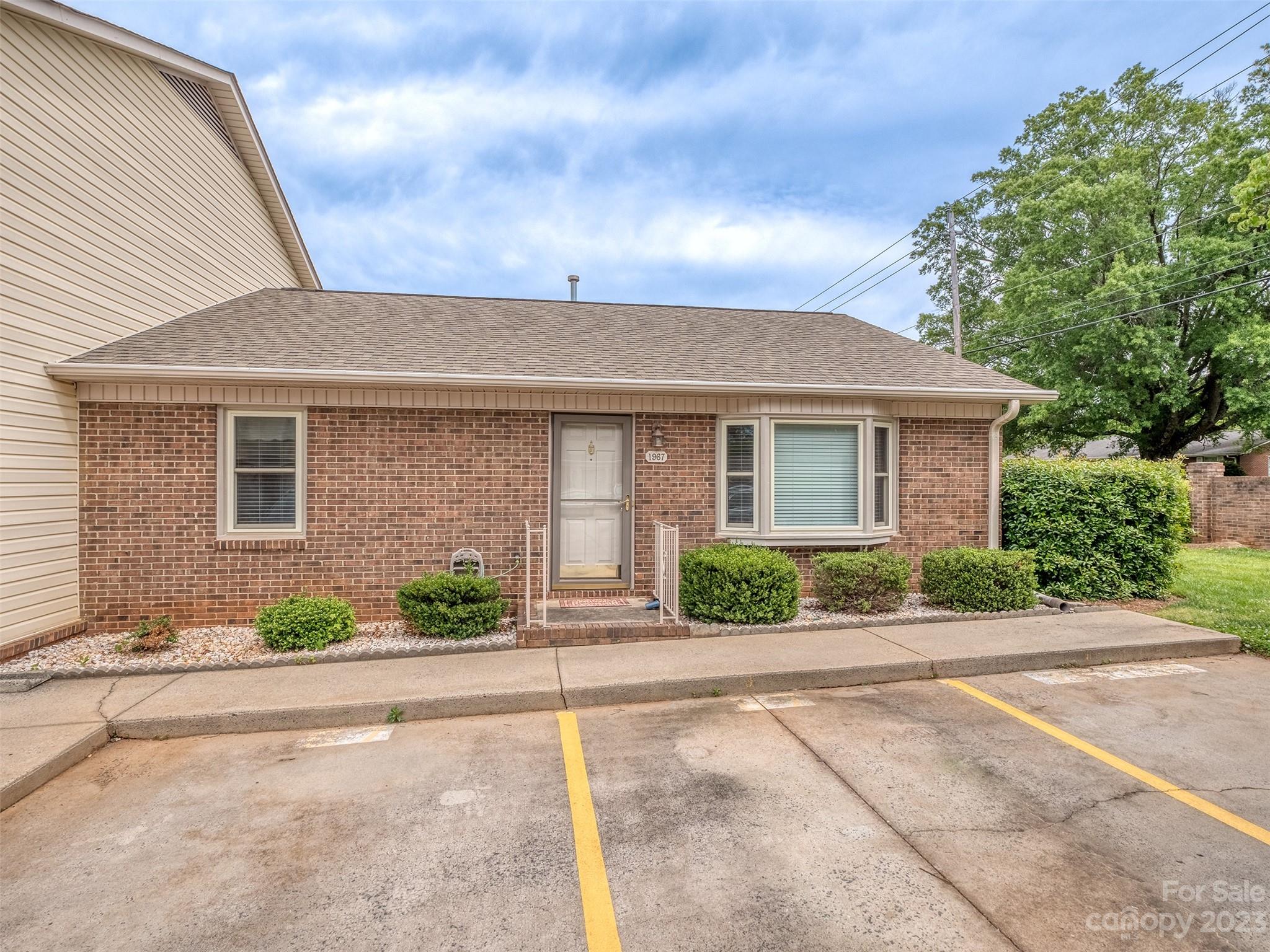a front view of a house with a yard and a garage
