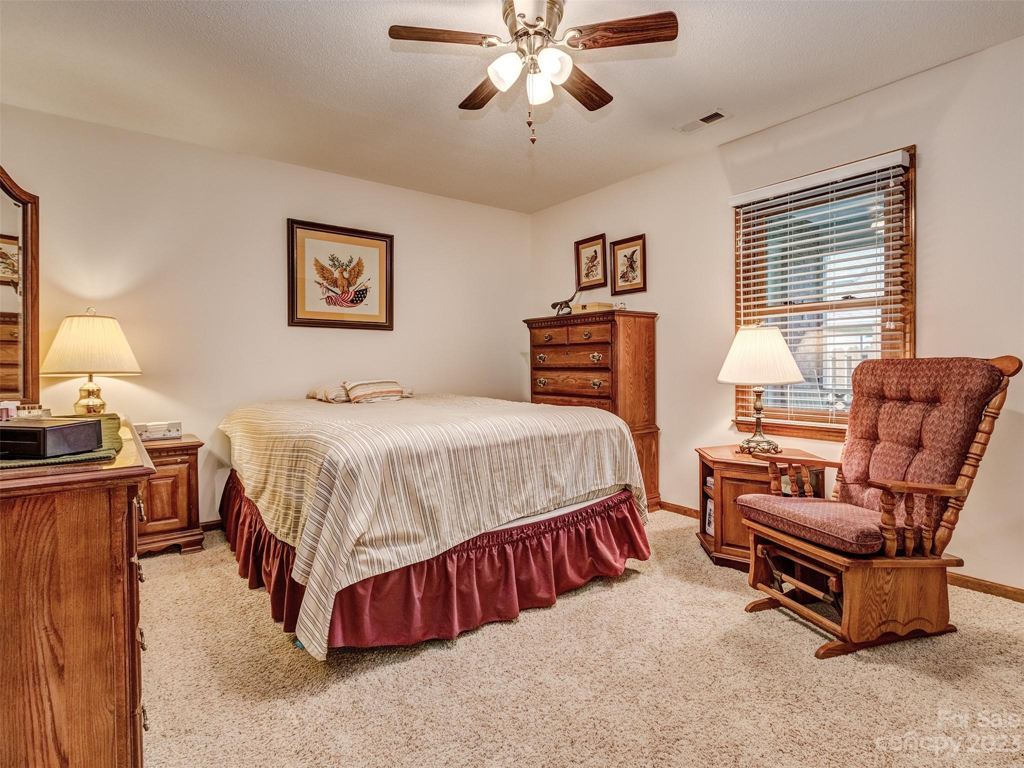 1967 Ebenezer Road Rock Hill, SC 29732 - Photo 17 of 26 a bedroom with a bed and a chandelier