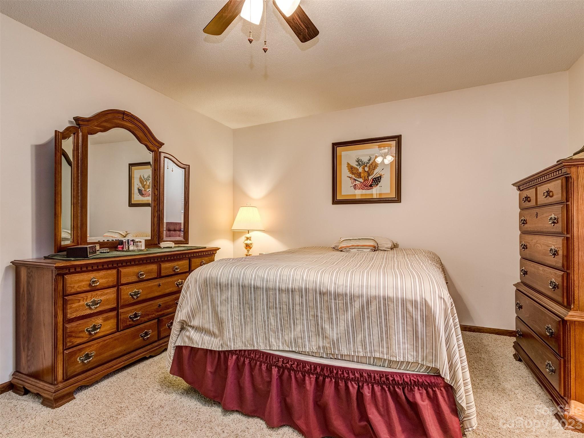 1967 Ebenezer Road Rock Hill, SC 29732 - Photo 18 of 26 a bedroom with a large bed and a chandelier