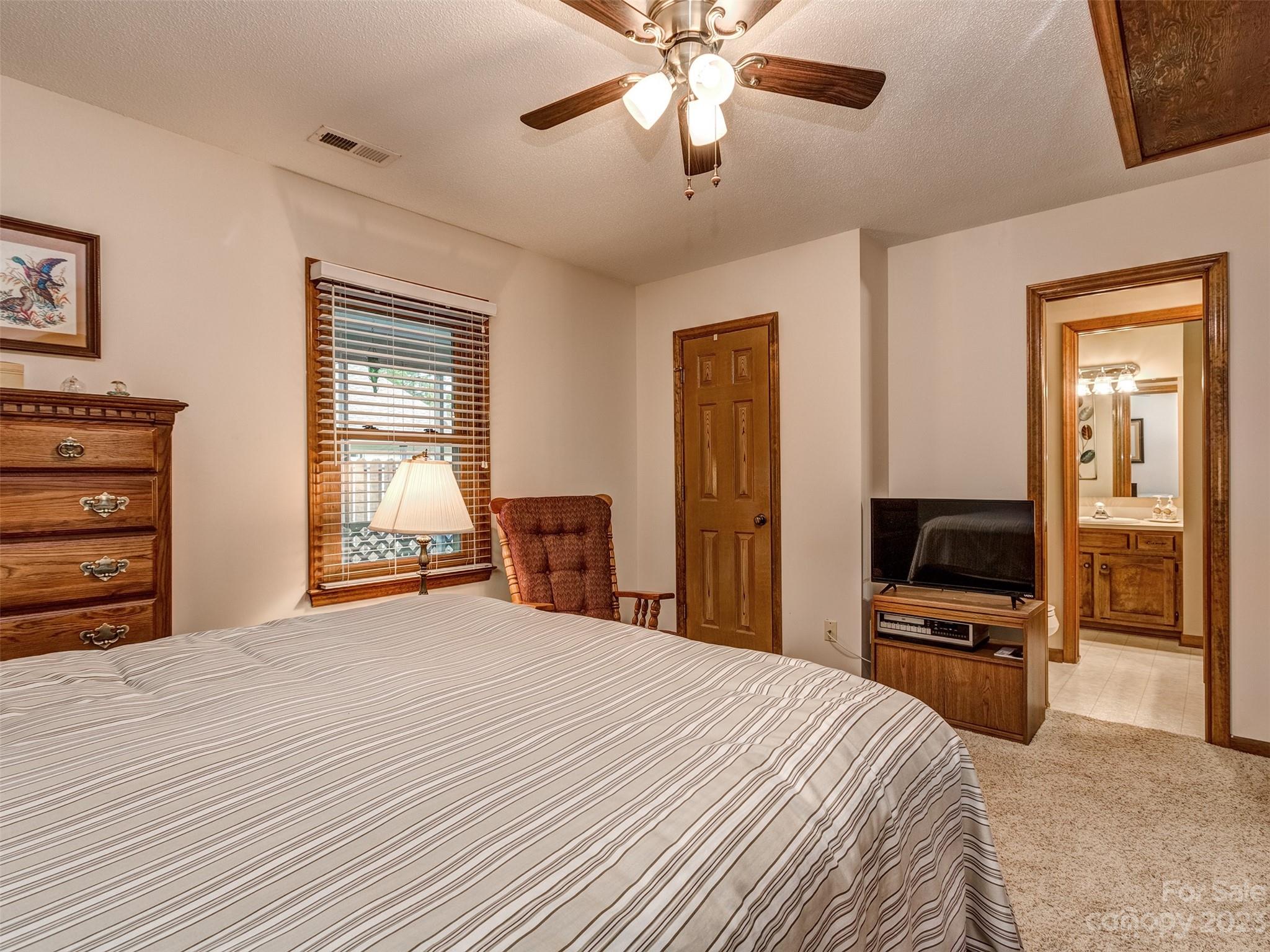 1967 Ebenezer Road Rock Hill, SC 29732 - Photo 19 of 26 a bedroom with a bed and a chandelier