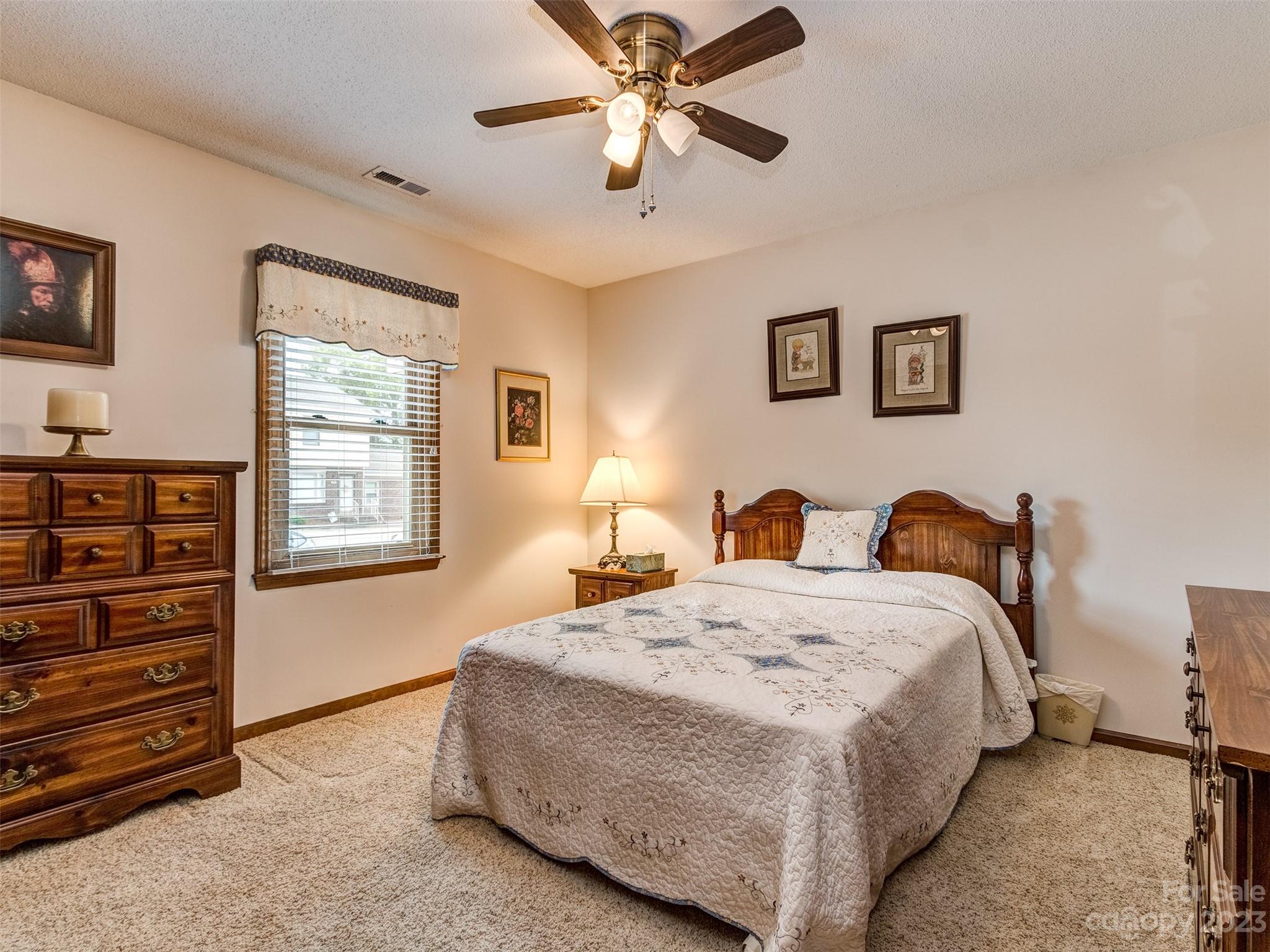 1967 Ebenezer Road Rock Hill, SC 29732 - Photo 20 of 26 a spacious bedroom with a bed and a chandelier