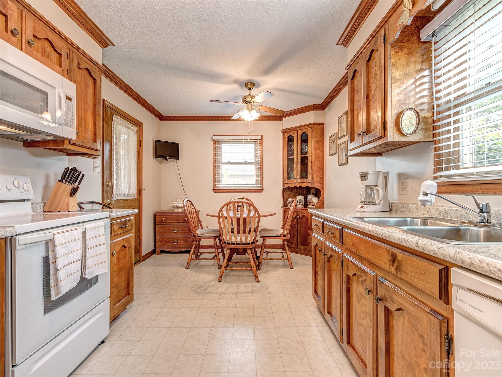 1967 Ebenezer Road Rock Hill, SC 29732 - Photo 10 of 26 a kitchen with stainless steel appliances granite countertop a stove top oven a sink a dining table and chairs with wooden floor